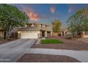 Beautiful two-story home with a well-manicured lawn, charming red door, and a spacious three-car garage at 5919 S Banning St, Gilbert, AZ 85298