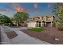 Charming two-story home with a spacious three-car garage and a well-maintained front yard at 5919 S Banning St, Gilbert, AZ 85298