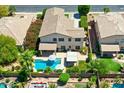 Aerial view of a beautiful home with a pool, patio, and well-maintained landscaping in a friendly neighborhood at 6570 S Pewter Way, Chandler, AZ 85249