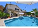Inviting backyard features a sparkling pool, covered patio with outdoor kitchen, pergola, and seating area at 6570 S Pewter Way, Chandler, AZ 85249