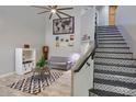 Bright living room with high ceilings, modern decor, tiled staircase, and large world map wall art at 6570 S Pewter Way, Chandler, AZ 85249