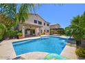 Backyard featuring a sparkling pool, covered patio, and lush landscaping, ideal for outdoor enjoyment at 6570 S Pewter Way, Chandler, AZ 85249