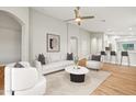 Bright living room with an open floor plan, neutral walls, and a ceiling fan at 6843 S 46Th Dr, Laveen, AZ 85339