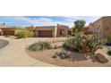 Single-level home's exterior is landscaped with native desert plants and trees at 7169 E Bramble Berry Ln, Scottsdale, AZ 85266