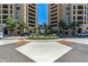 Beautiful condo building entrance with landscaping, circular drive and guest parking spots at 7175 E Camelback Rd # 510, Scottsdale, AZ 85251