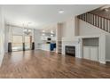 Stylish living area boasting hardwood floors, a modern fireplace, and seamless access to a bright, open kitchen area at 7204 S Golfside Ln, Phoenix, AZ 85042