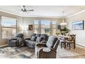 Open-concept living space with plush seating and adjacent dining area with large windows at 7601 E Indian Bend Rd # 3002, Scottsdale, AZ 85250