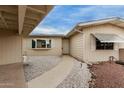 Inviting front entrance with a walkway, desert landscaping, and neutral siding at 8337 E Desert Trl, Mesa, AZ 85208