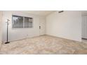 Bright bedroom features tile floors, a window, and a door for ample natural light and accessibility at 870 S Palm Ln # 55, Chandler, AZ 85225