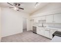 Well-lit kitchen features a ceiling fan, ample cabinet space, and tiled floors at 870 S Palm Ln # 55, Chandler, AZ 85225