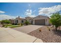 Charming home with a tile roof, two-car garage, and desert landscaping at 9281 W Villa Chula --, Peoria, AZ 85383
