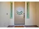 Stylish front door with decorative wreath and sidelights at 9281 W Villa Chula --, Peoria, AZ 85383