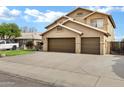 Spacious three-car garage, large driveway, and well-maintained desert landscaping at 1215 W Wahalla W Ln, Phoenix, AZ 85027
