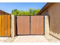 A wooden gate in the backyard, offering privacy and security at 14208 W Larkspur Dr, Surprise, AZ 85379