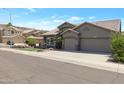 Charming single-Gathering home with a well-manicured lawn, desert landscaping, and a two-car garage at 14801 S 8Th St, Phoenix, AZ 85048