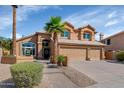Welcoming home featuring a three-car garage, lush greenery, desert landscaping, and a charming front entrance at 15020 S 25Th St, Phoenix, AZ 85048