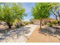 Charming single-story home with mature trees, desert landscaping, and a spacious driveway at 15107 E Desert Willow Dr, Fountain Hills, AZ 85268