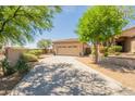 Charming single-story home with mature trees, desert landscaping, and a spacious driveway at 15107 E Desert Willow Dr, Fountain Hills, AZ 85268