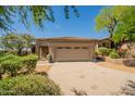 Lovely single-story home featuring a tile roof, stone accents, and a two-car garage at 15107 E Desert Willow Dr, Fountain Hills, AZ 85268
