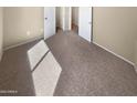 Cozy bedroom with soft carpeting and ample natural light at 15369 W Wethersfield Rd, Surprise, AZ 85379