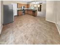 Well-lit kitchen with stainless steel appliances, tile flooring, and wooden cabinetry at 15369 W Wethersfield Rd, Surprise, AZ 85379