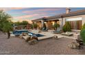 Resort-style backyard features a pool, spa, fire pit, and outdoor kitchen, perfect for entertaining at 1713 W Calle Marita --, Phoenix, AZ 85085
