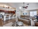Open concept living room flowing into kitchen and dining area with lots of natural light at 17162 N Winding Trl, Surprise, AZ 85374