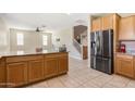Open concept kitchen with stainless steel appliances and ample cabinet space flowing into living area at 17425 W Willow Ave, Surprise, AZ 85388