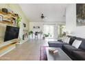Spacious living room with large sectional, shelving, and access to the outdoors at 1810 N Sunaire Cir, Mesa, AZ 85205