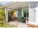 Inviting front porch with colorful door and plantings that enhance curb appeal at 1810 N Sunaire Cir, Mesa, AZ 85205