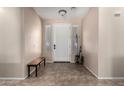 Inviting entryway with neutral walls, tiled flooring, and stylish bench seating at 18492 E Oak Hill Ln, Queen Creek, AZ 85142