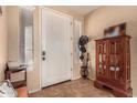 Inviting entryway with decorative tiled floors, a white front door, and natural lighting at 18492 E Oak Hill Ln, Queen Creek, AZ 85142