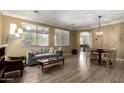 Bright living room featuring hardwood floors, modern furnishings, and natural light at 18492 E Oak Hill Ln, Queen Creek, AZ 85142