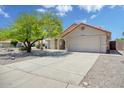 Beautiful single-story home featuring a well-kept lawn, desert landscaping, and spacious two car garage at 18802 N 71St Ln, Glendale, AZ 85308