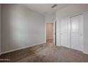 Comfortable bedroom with carpet flooring, standard closet with sliding doors, and neutral colored walls at 1917 S 246Th Ln, Buckeye, AZ 85326