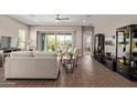 Relaxing living room with tile floors, a ceiling fan, sliding glass doors and modern furnishings at 1919 W Plum Rd, Phoenix, AZ 85085