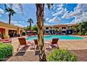 Inviting community pool with comfortable lounge chairs and well-maintained landscaping at 1941 S Pierpont Dr # 1099, Mesa, AZ 85206