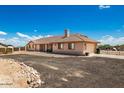 Back of single-story home featuring a well-manicured yard, a convenient access to the garage at 20041 W Colter St, Litchfield Park, AZ 85340