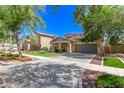 Charming two-story home with two-car garage, desert landscaping, lush green lawn, and long driveway at 20709 W Delaney Dr, Buckeye, AZ 85396