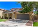 Charming two-story home with two-car garage, desert landscaping, lush green lawn, and a covered porch at 20709 W Delaney Dr, Buckeye, AZ 85396