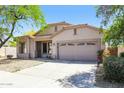 Single-story home with a two-car garage and well-maintained landscaping adding to its curb appeal at 2401 W Ellis St, Phoenix, AZ 85041