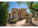 Charming single-Gathering home featuring a landscaped front yard, a two-car garage, and a welcoming entrance at 2406 N 142Nd Ave, Goodyear, AZ 85395
