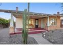 Inviting covered front porch featuring a bench, brick accents, and desert landscaping at 2534 N 10Th St, Phoenix, AZ 85006