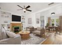 Bright living room features a cozy fireplace, ceiling fan, and comfortable seating area at 2534 N 10Th St, Phoenix, AZ 85006