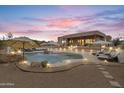 Backyard with a luxurious private pool, desert landscaping, and elegant patio furniture under sunset at 3019 W Trail Dr, Phoenix, AZ 85086