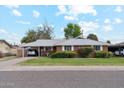 Charming brick home featuring a well-manicured lawn and mature landscaping at 3616 E Fairmount Ave, Phoenix, AZ 85018