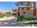 Two-story home featuring a terracotta roof, decorative wall, and desert landscaping at 635 N Yale Dr, Gilbert, AZ 85234