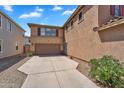 Side view of house featuring a two car garage and spacious driveway at 6469 W Ruth Ave, Glendale, AZ 85302