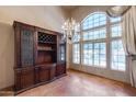 Dining room with a beautiful chandelier, built in shelving, and a large window overlooking the pool at 7217 S Hazelton Ln, Tempe, AZ 85283