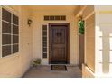 Inviting entryway featuring a rustic wood door and a charming welcome mat at 7512 W Tonto Dr, Glendale, AZ 85308